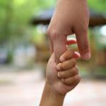 Parent holding hand with child