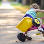 Child falling off tricycle