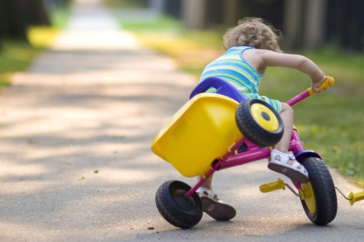 Child falling off tricycle